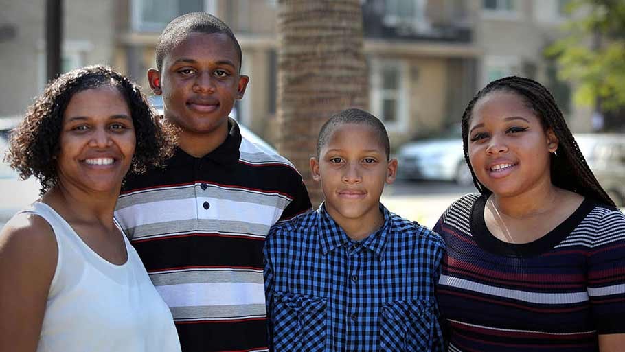 A family that is excited to have moved in to their new affordable home at Jamboree's Clark Commons.