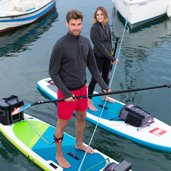 Male and Female paddle boarding.