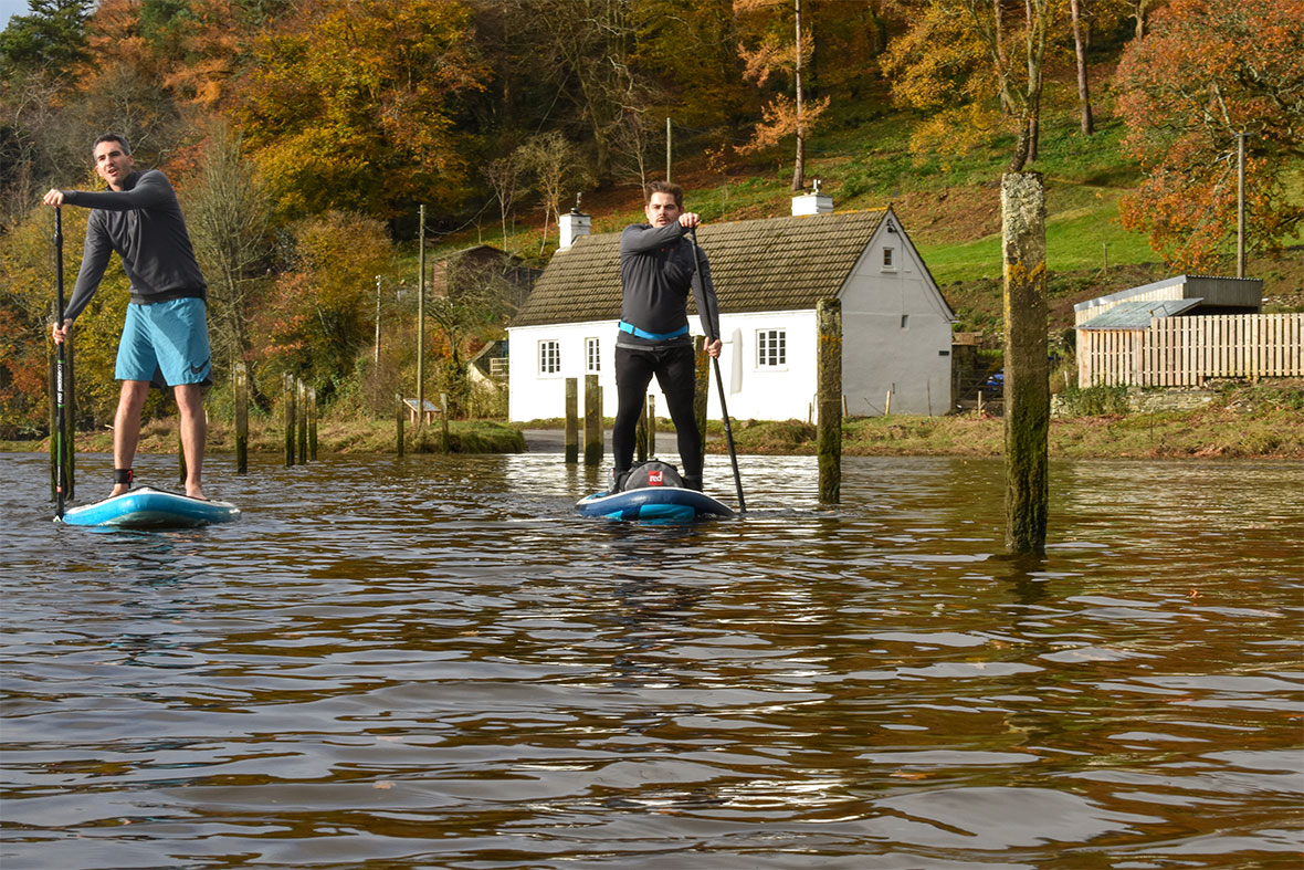 Two males on stand up paddle boards