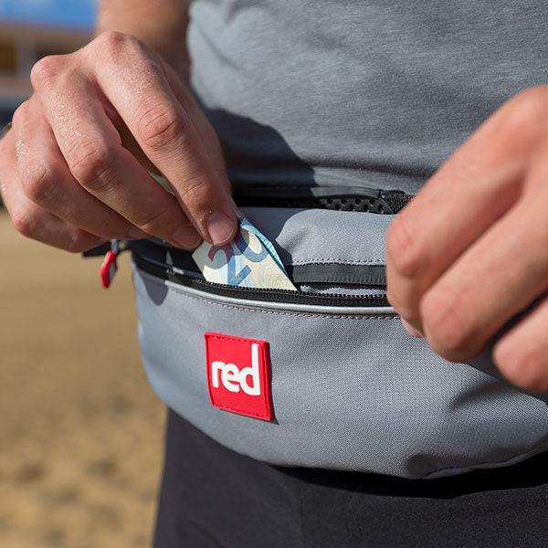Male puts money in Airbelt pocket