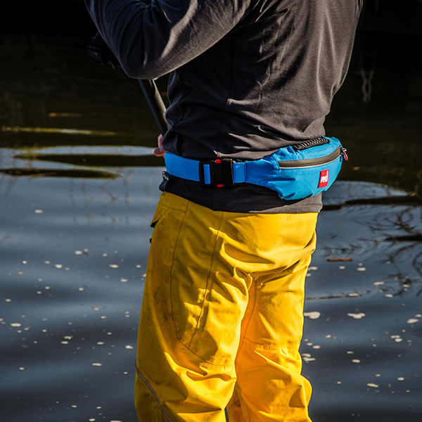 Man paddle boarding wearing dry trousers.