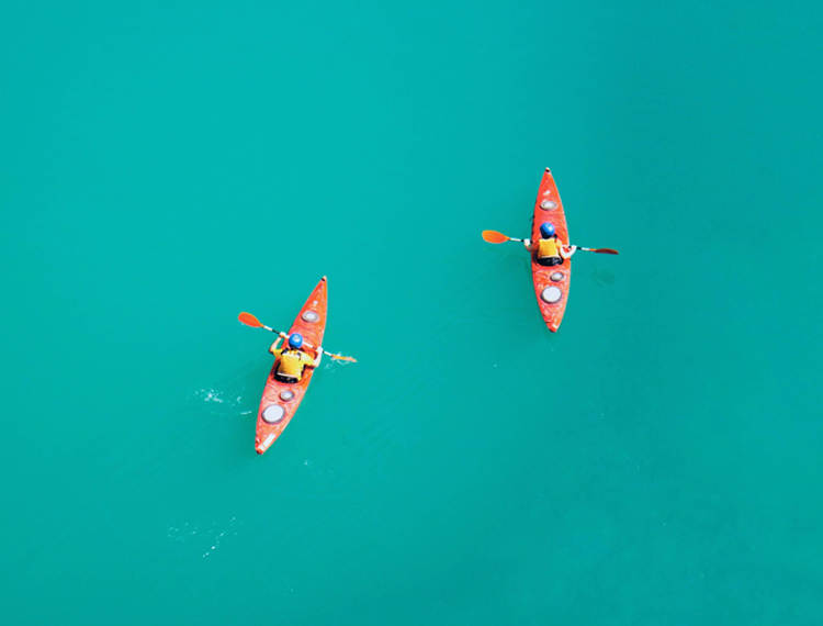 2 People Sea Kayaking In The Ocean