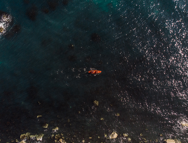 A Panned Out Shot Of Someone Sea Kayaking