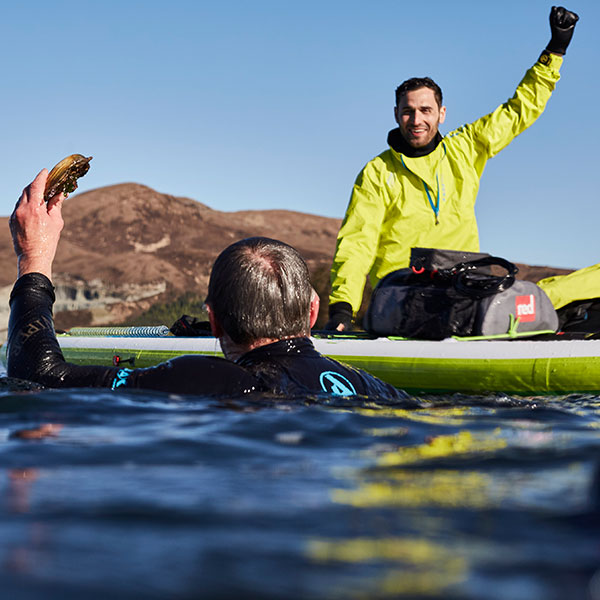 Man swims searching for oysters.