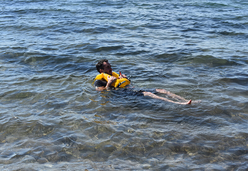 Man Floating In The Sea With An Inflated Airbelt PFD
