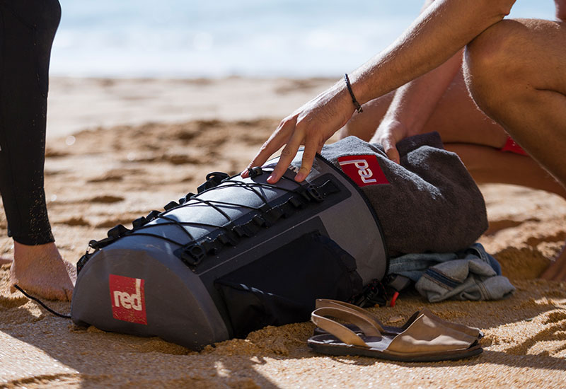 packing a Red Original luxury changing robe into a deck bag