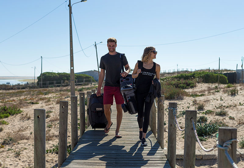 Walking to the beach with paddle board equipment