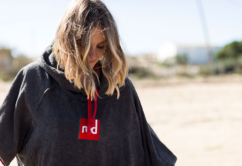 Woman getting changed with her Red Original Luxury Change Robe