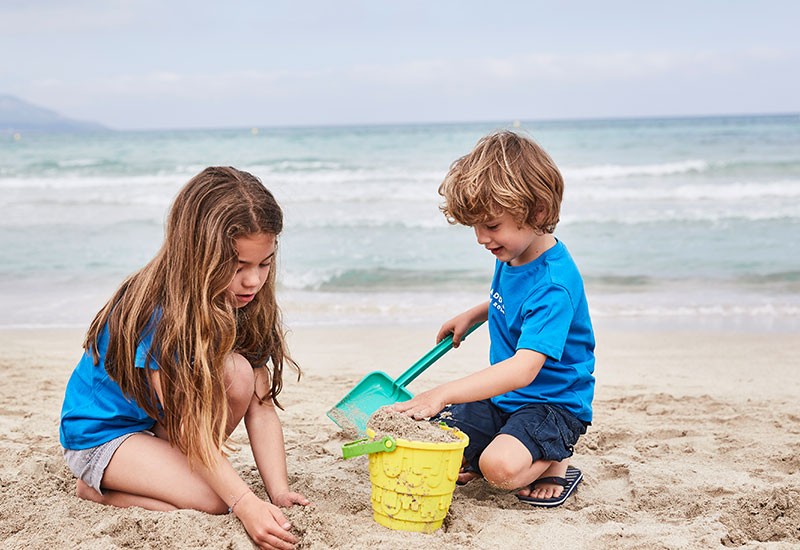 children making sandcastles at beach
