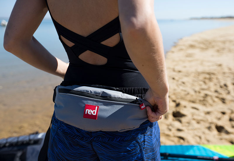 Woman attaching a Red Original Airbelt PFD