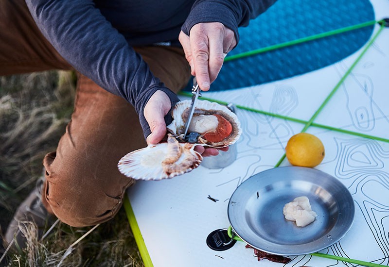 man cooking oysters outside