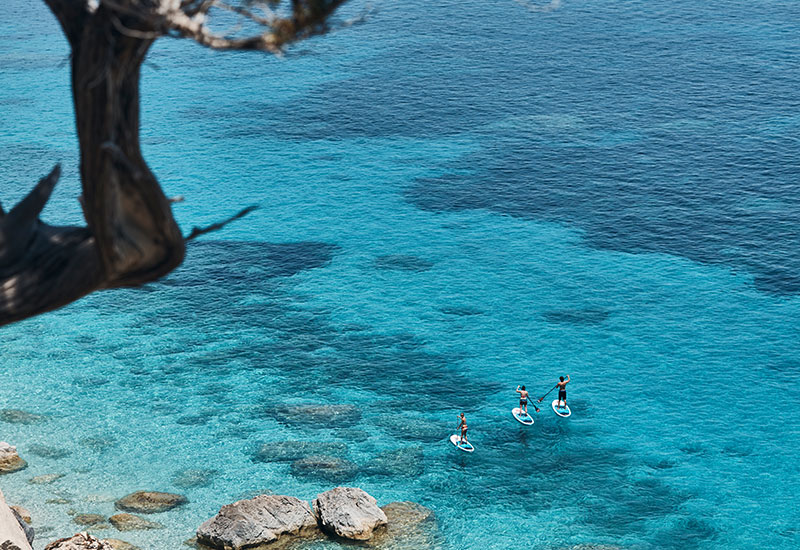 three friends out paddle boarding