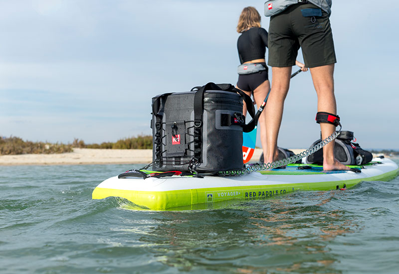 Paddling with the Red Original cool bag attached to the back of the board