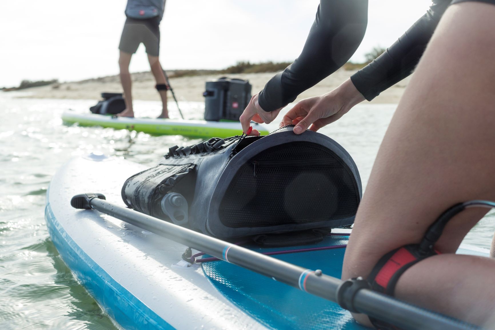 Opening a Red Original Waterproof Deck Bag whilst on the water