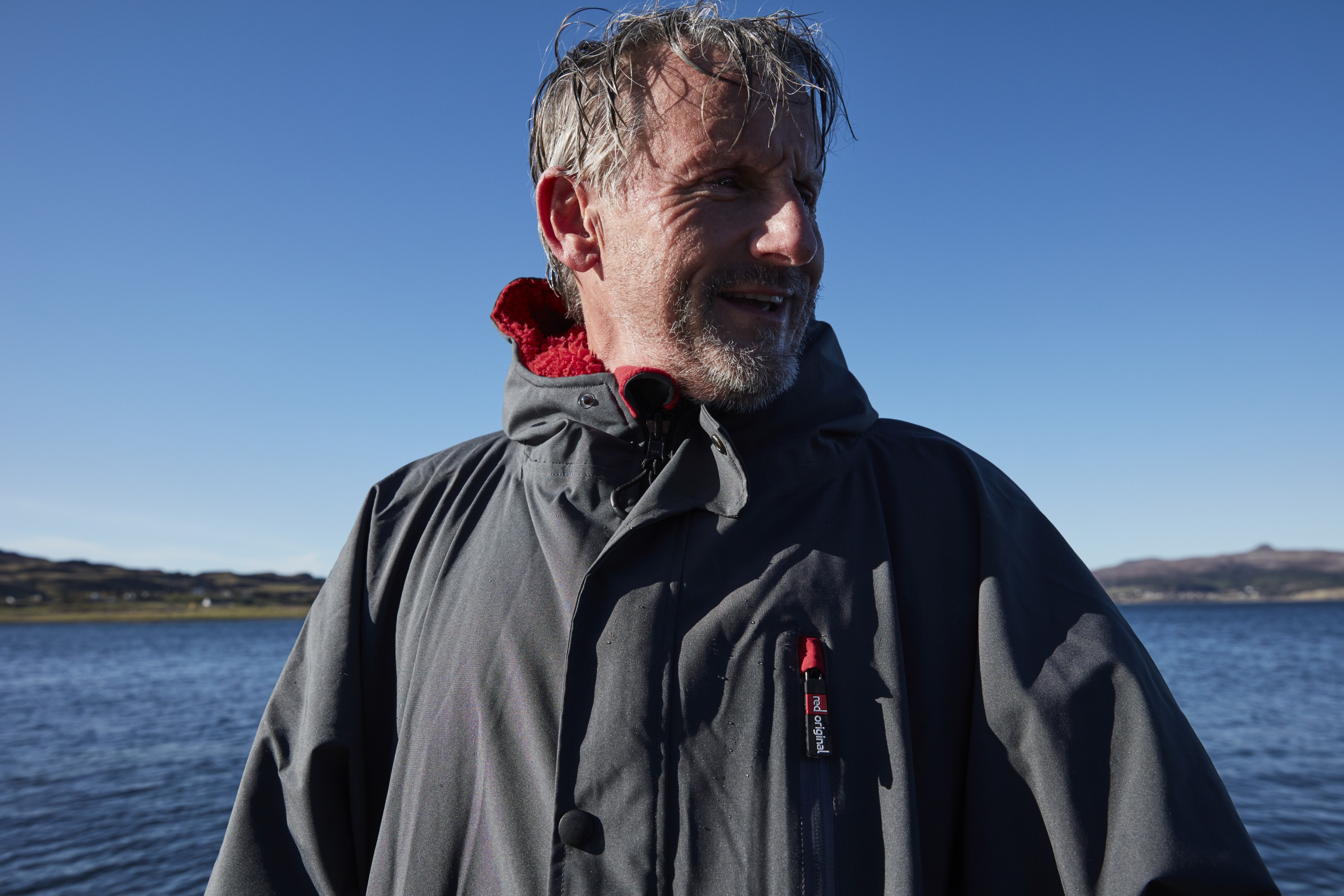 Man drying off with Red Original Pro Change Jacket